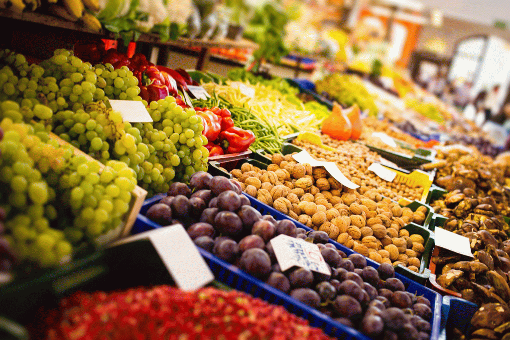 A variety of fruits and vegetables are on display at a market.