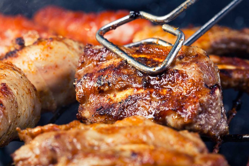 Celebrate Australia Day with perfectly grilled meat, expertly flipped with a spatula on the grill.