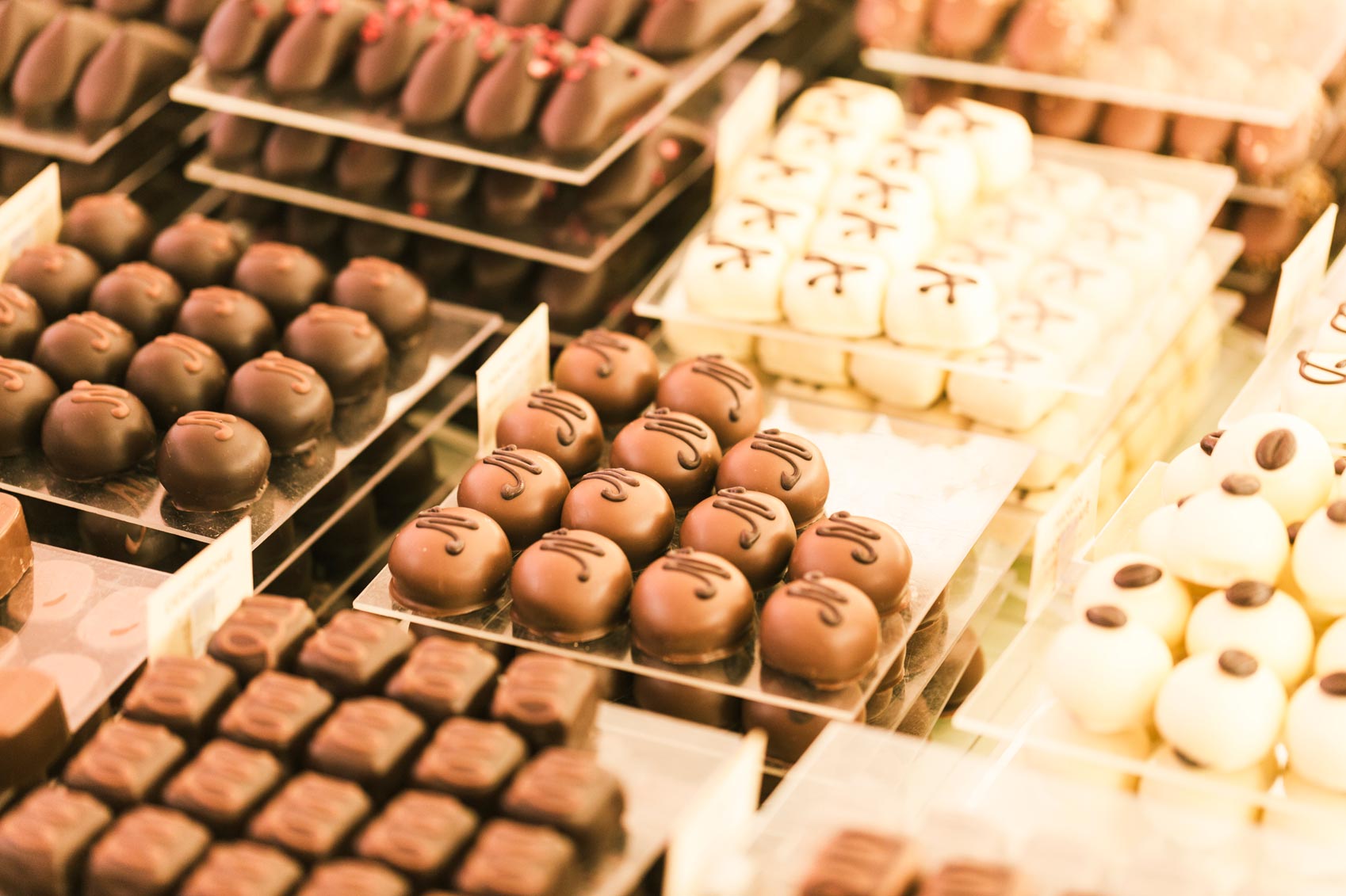 A display of chocolates in a store, perfect for indulging your sweet tooth or finding a delicious treat to bring back home when traveling with kids.