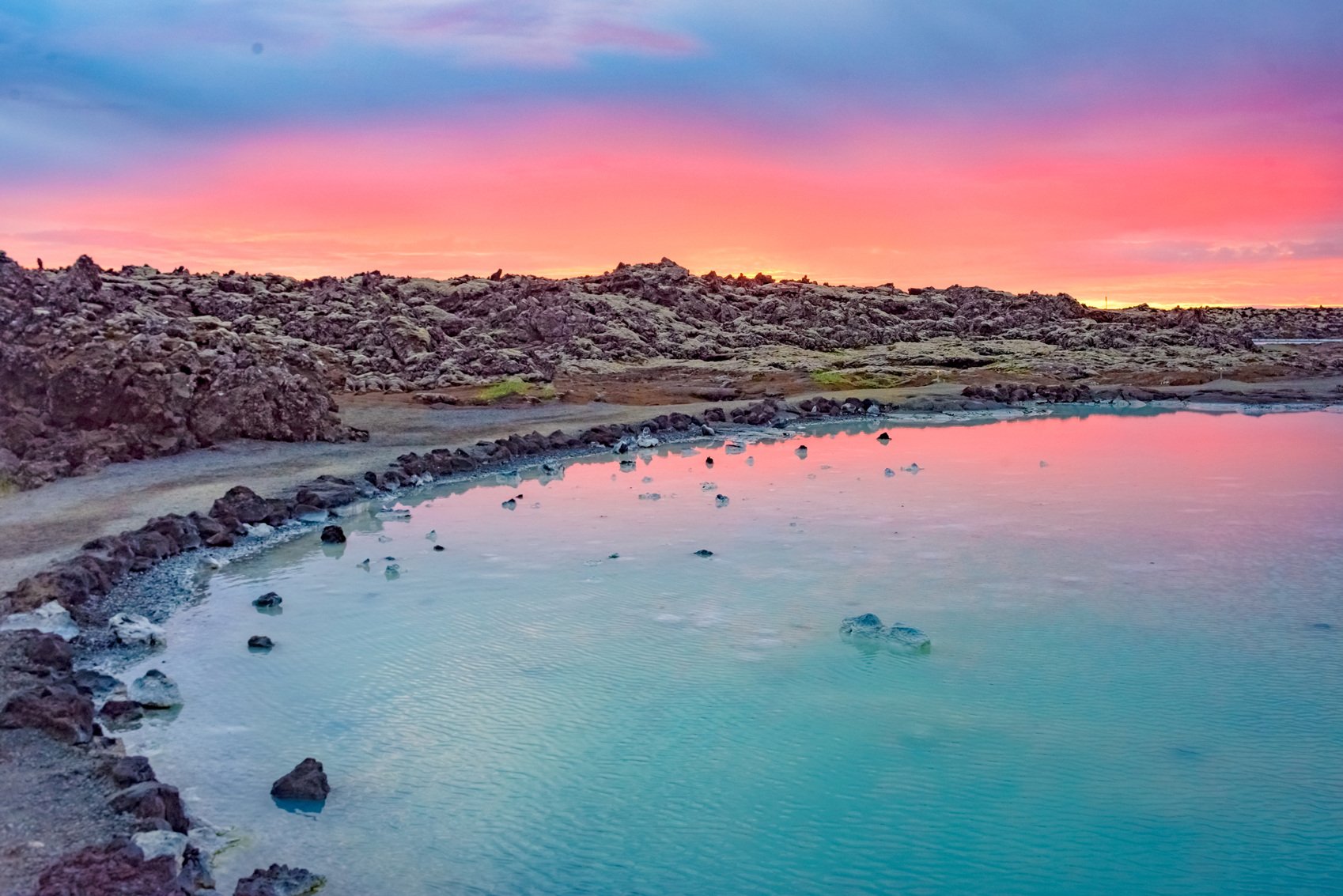 A colorful sunset over a hot spring in Iceland to welcome the New Year.