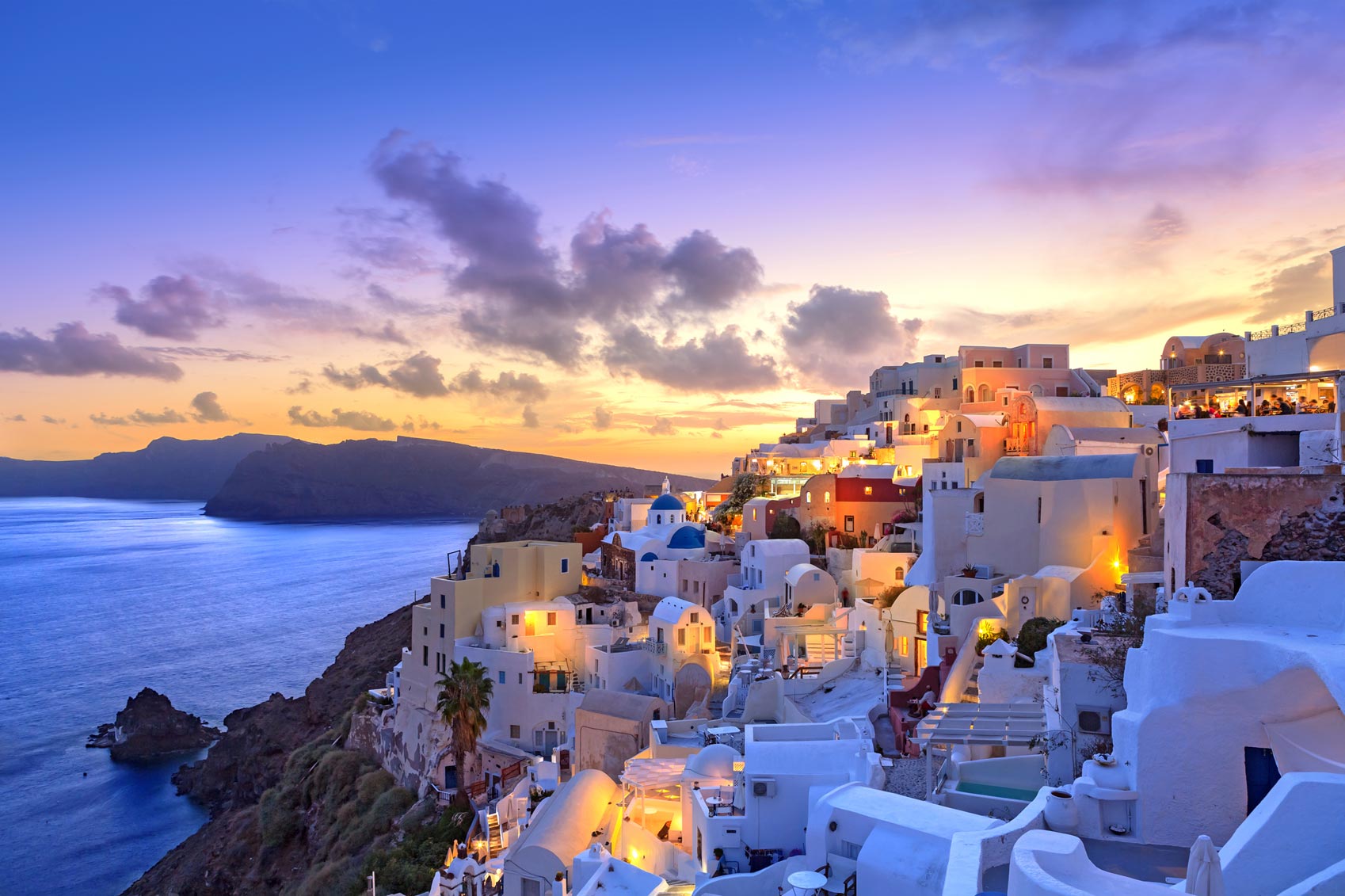 Oia, Santorini, Greece at sunset is a mesmerizing travel destination that offers a captivating experience for families looking to adventure with kids.