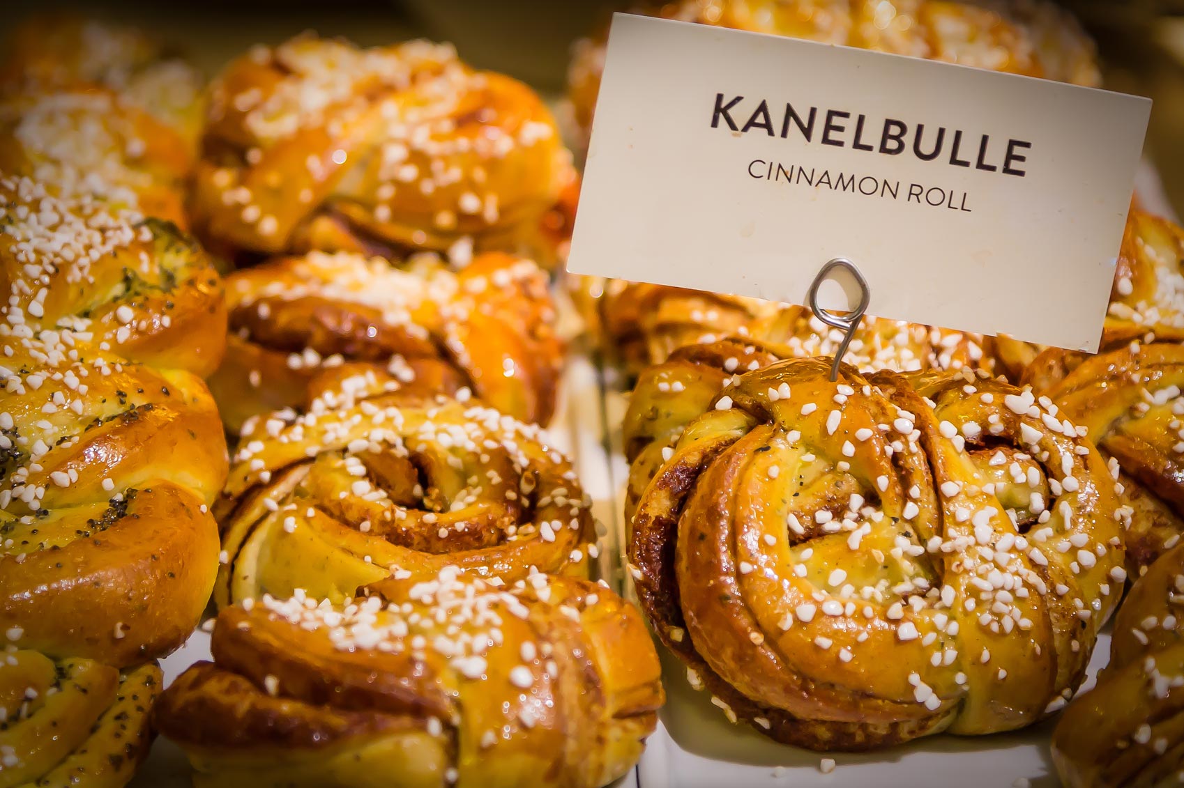 As part of my travel resolutions, I came across a delightful display of cinnamon buns. Each bun was perfectly baked and showcased beautifully, inviting anyone passing by to indulge. A small sign embell