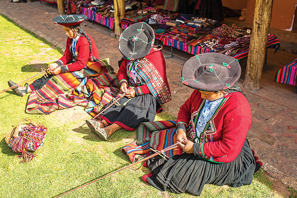 A peruvian woman wearing a hat.