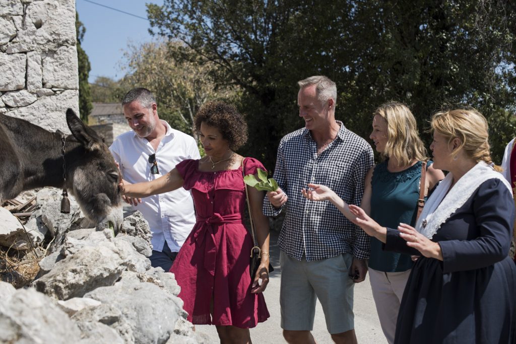 A group of people feeding an osojnik.