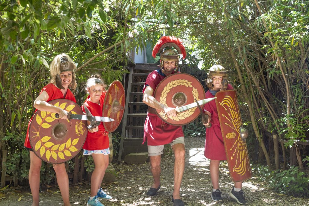 A group of people dressed up in roman costumes.