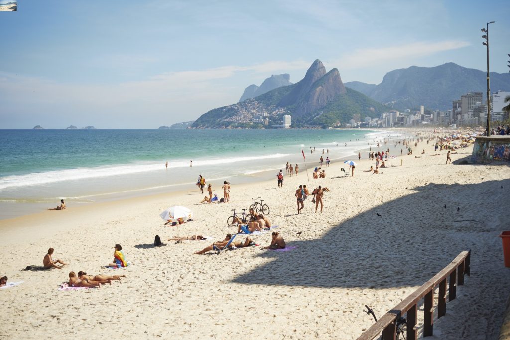 A group of people on a beach in rio.