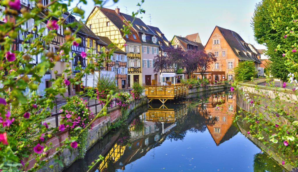 A canal runs through a town in france.