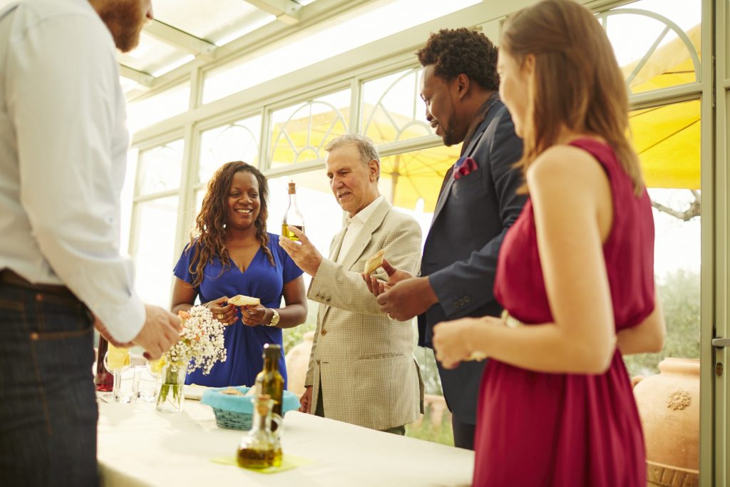 A group of people standing around a table.