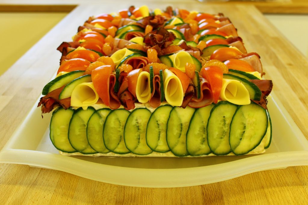 A plate of vegetables and meat on a table.