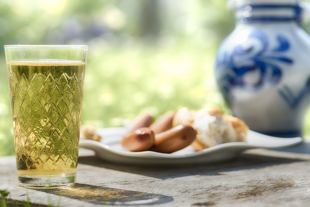A glass of beer next to a plate of hidden gems in Germany.
