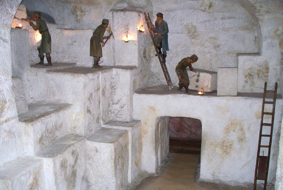 A group of men are exploring a cave.