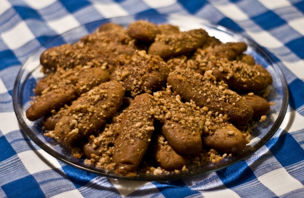 A plate of cookies and granola on a blue and white checkered tablecloth.