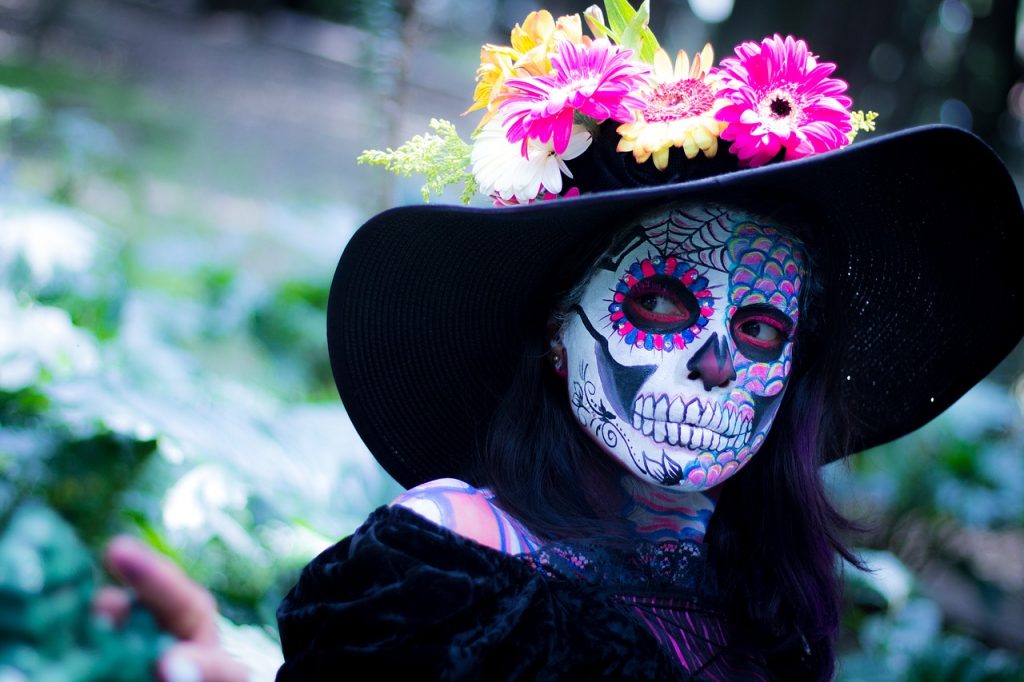 girl with painted skull face day of the dead tradition