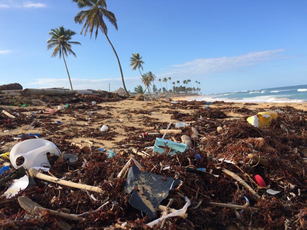A beach covered in single-use plastic trash.