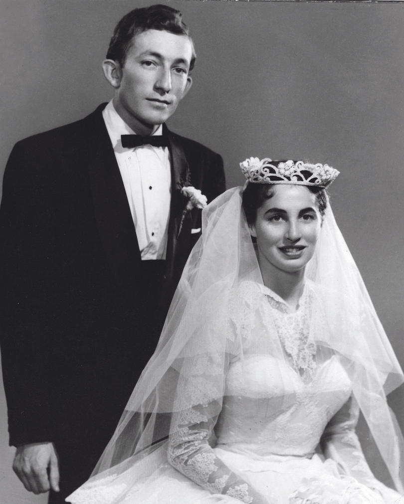 A black and white photo of a man and woman posing for a TTC 100.