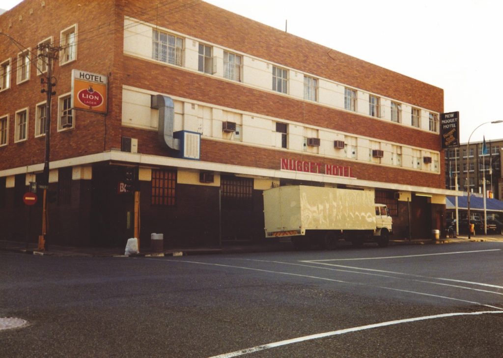 A brick building with a parked truck in front of it.
