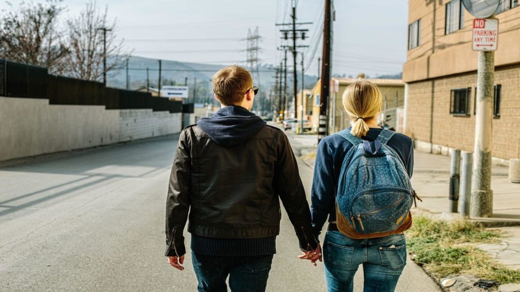 couple holding hands travel safety tips