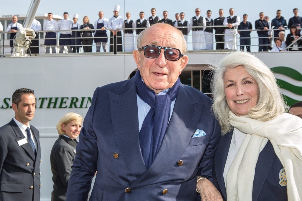 A man and woman standing side by side, gazing at the water together on a boat for Valentine's Day.