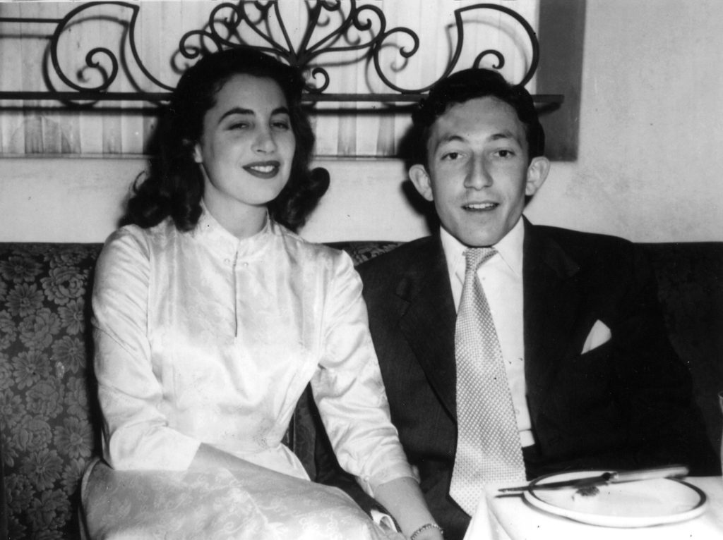 An old black and white photo of a man and woman sitting at a table on Valentine's Day.