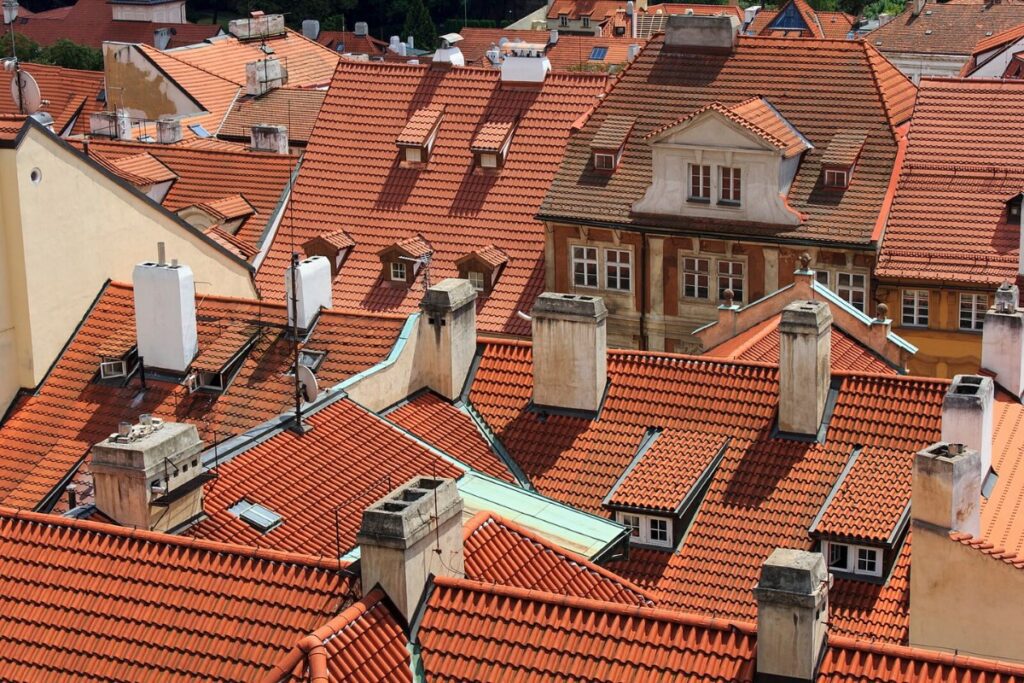 Birds-eye view of multiple buildings, all with red roofs.