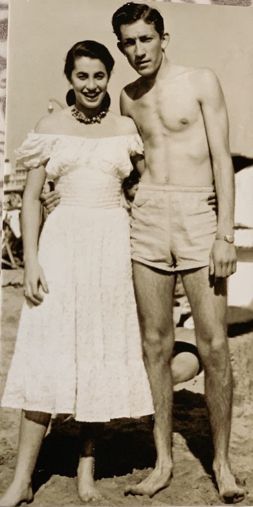 An old photo of a man and woman at the beach on Valentine's Day.