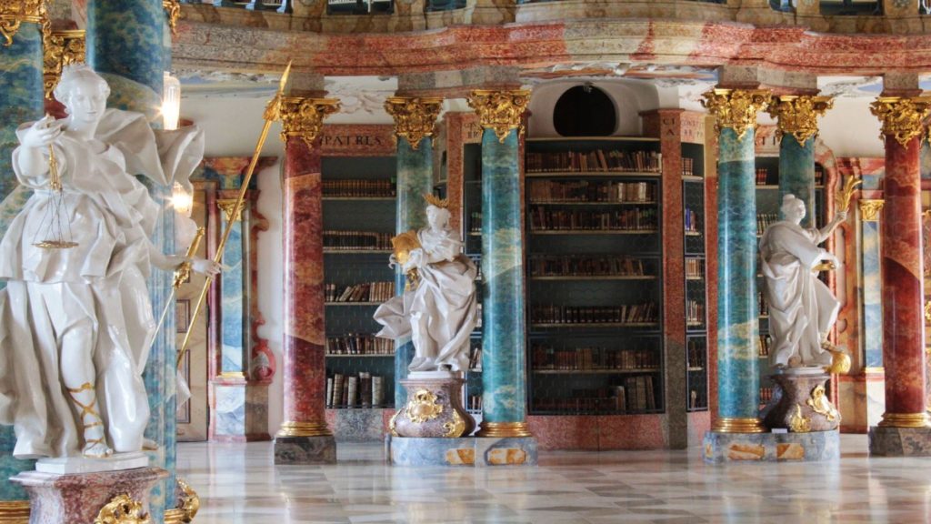 One of the most beautiful libraries in the world, featuring ornate statues and bookshelves.