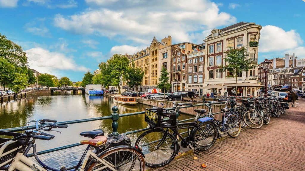 Bicycles parked along a canal in Amsterdam, perfect for a Zoom family quiz.