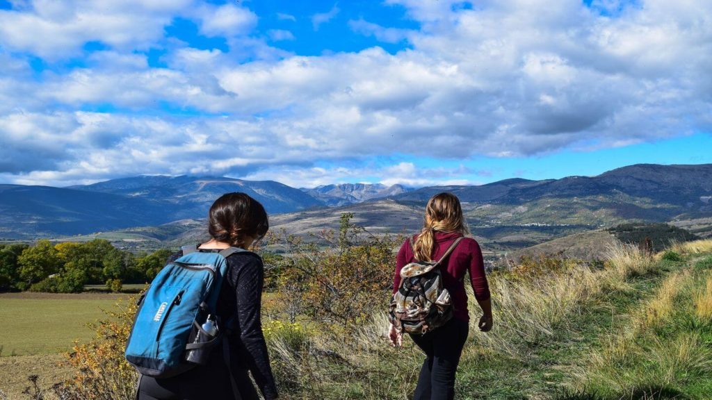 two people hiking mountain walking trail