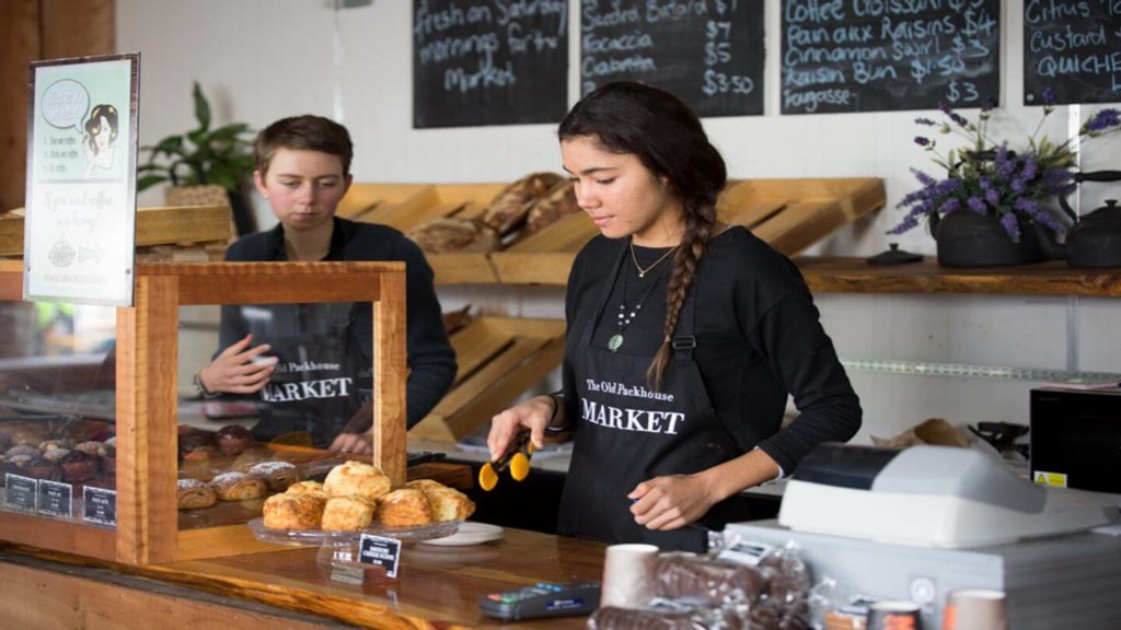 two young people working at a bakery in the Old Packhouse Market New Zealand