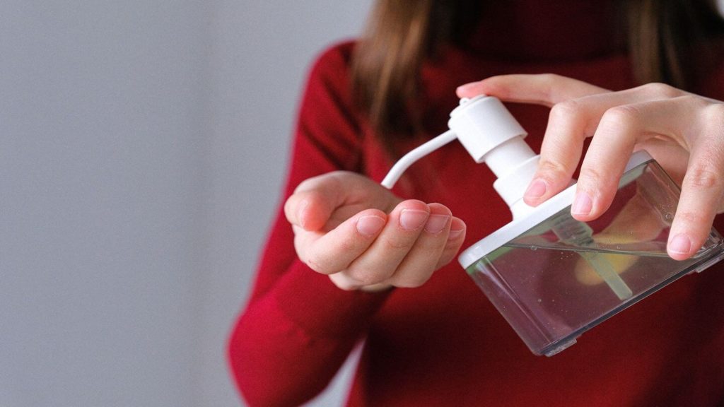 person applying hand sanitiser 