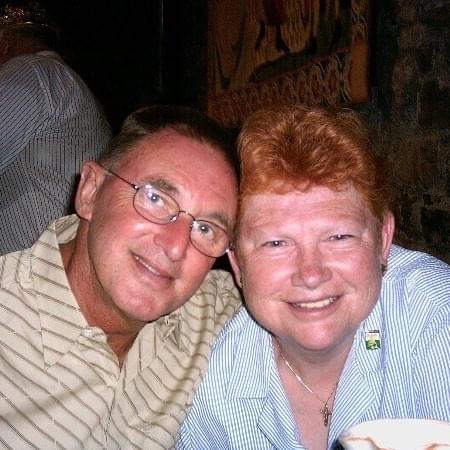 A couple posing for a photo at a restaurant while travelling in Ireland.