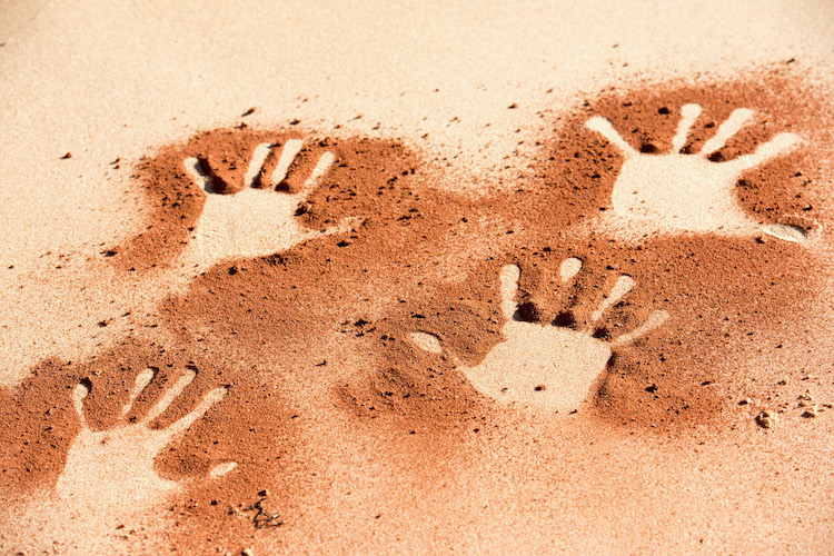 Hand prints in red sand in Australia's Northern Territory 
