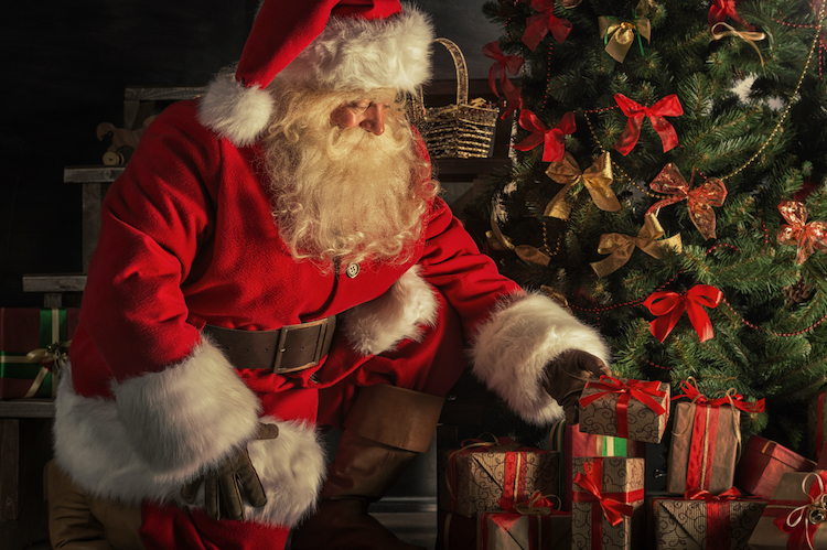 ‘Viejito Pascuero’ also known as Santa Clause or Old Man Christmas placing presents around Christmas tree