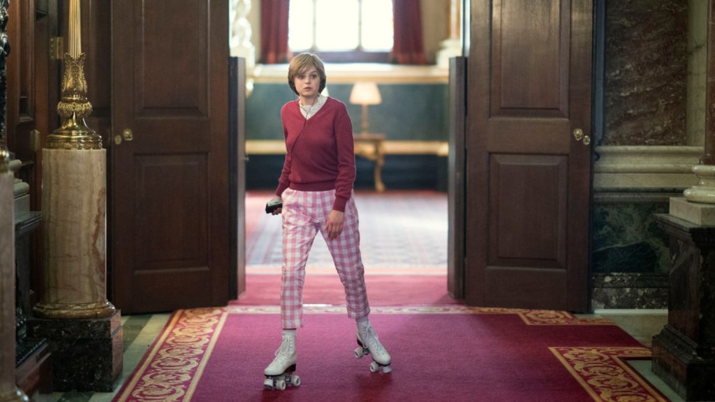 A person roller skating indoors through an opulent hallway reminiscent of a scene from "The Crown" TV series.