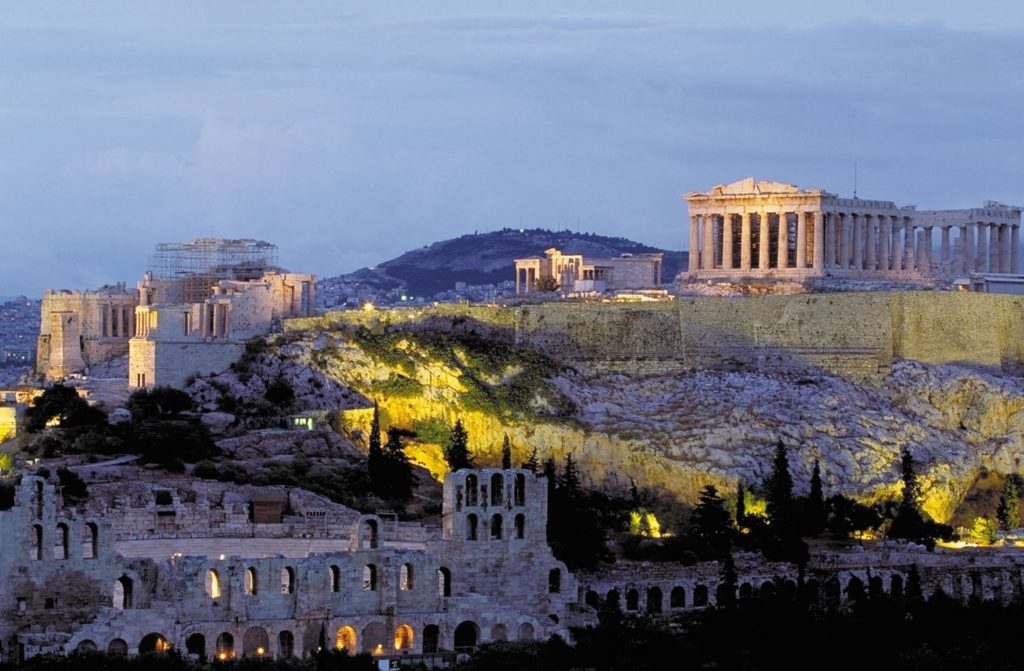 Illuminated ancient ruins on the acropolis of Athens against the evening sky, now a highlight on Europe's biggest attractions list.