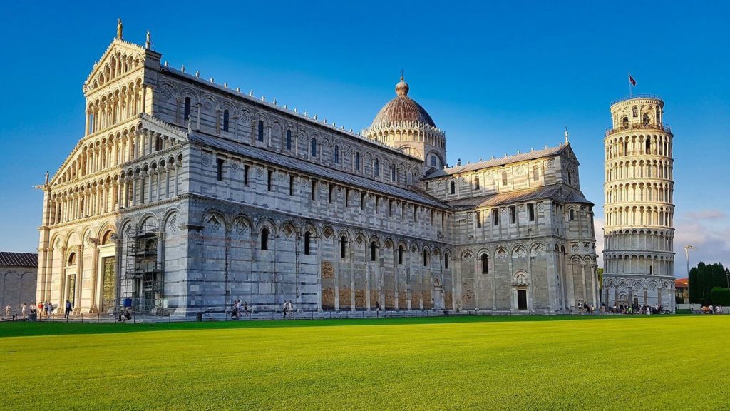 The Pisa Cathedral and the Leaning Tower of Pisa, Europe's biggest attractions, at sunset.