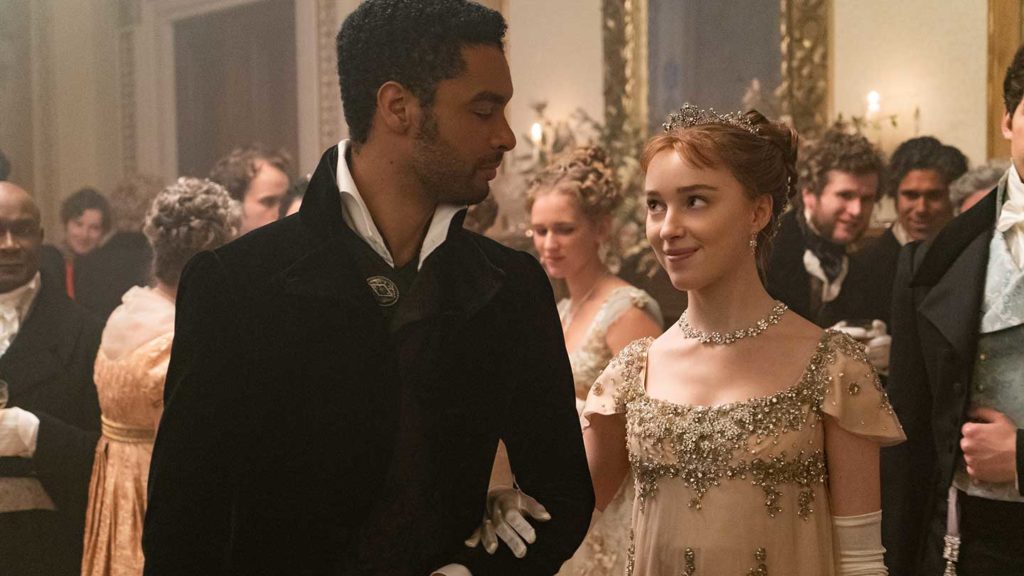 A man and a woman in regency era costumes at a ballroom event, reminiscent of 2021 destinations.