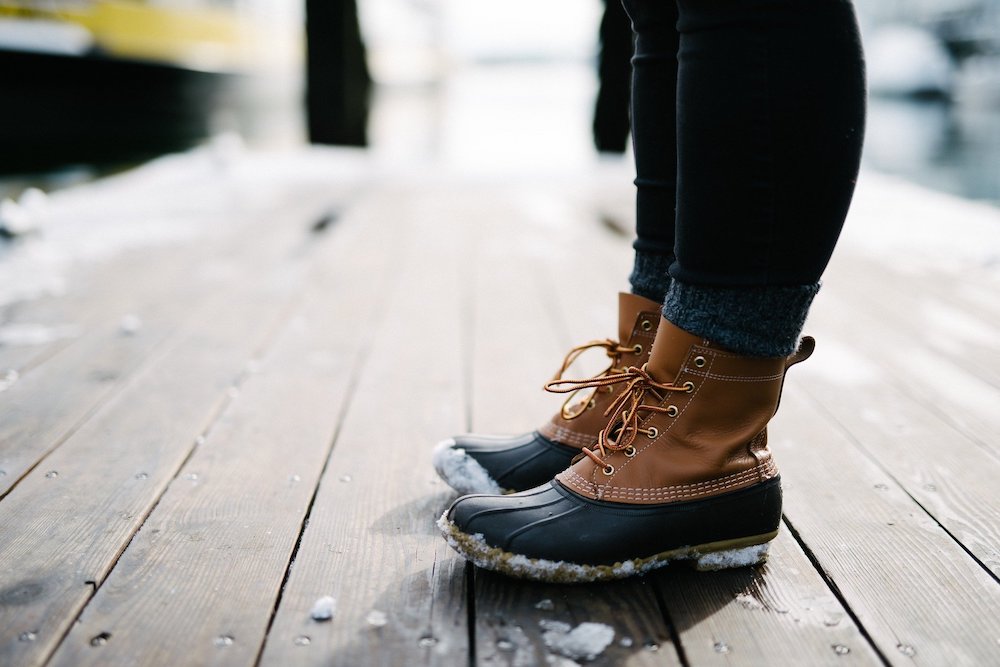 Brown winter boots covered in snow.