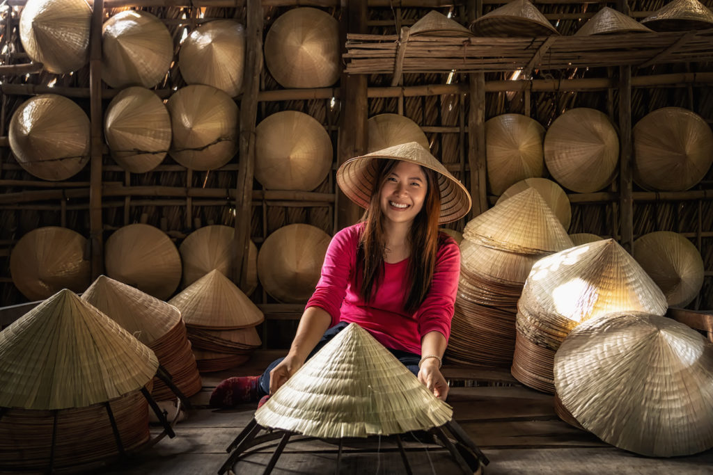 A woman making straw hats in Vietnam