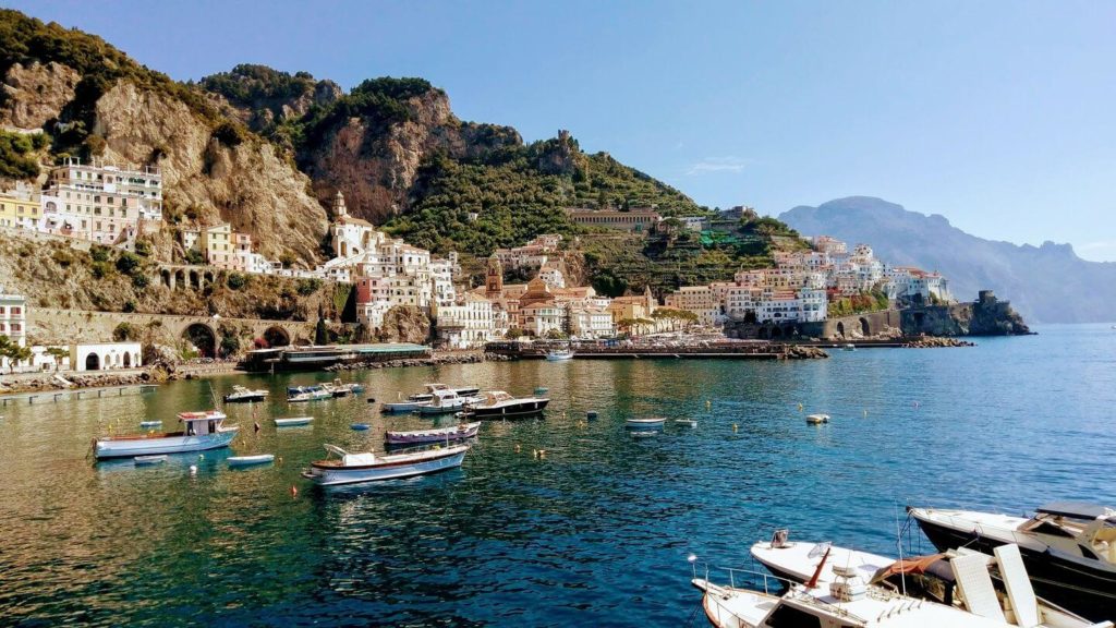 boats cliffside houses Italy summer