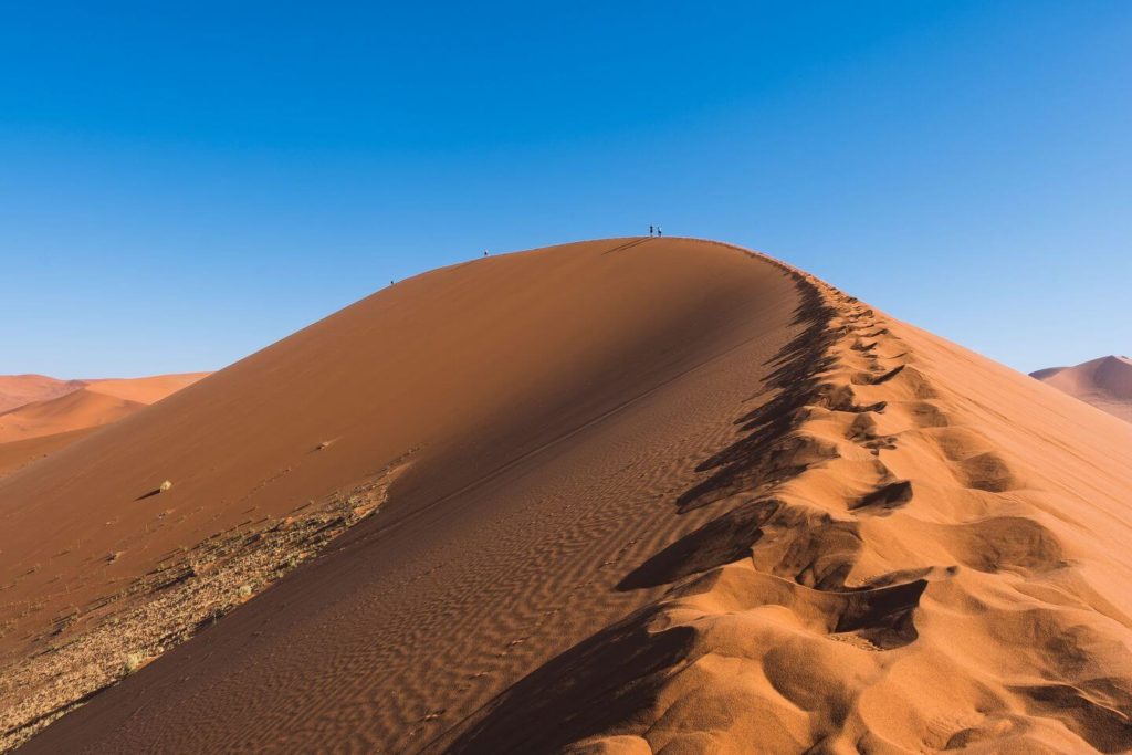 orange sand dunes blue sky Namibia