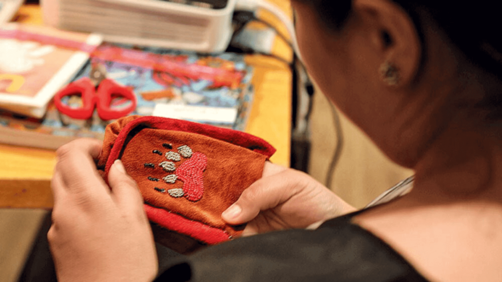 artisan creating moccasins at the Manitobah Mukluks Storyboot School Quebec