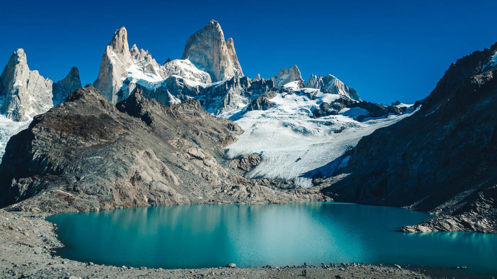 Glacial lake with turquoise water set against a backdrop of rugged mountain peaks and glaciers in UNESCO-listed Patagonia, a must-visit on any adventure seeker's bucket list.