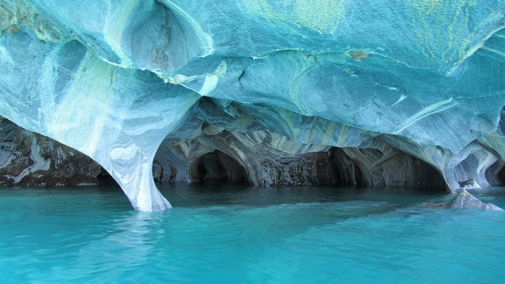 Turquoise waters beneath a UNESCO-listed, naturally sculpted marble cave system.