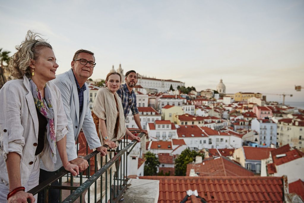 two couples looking out over a scenic viewpoint in Italy