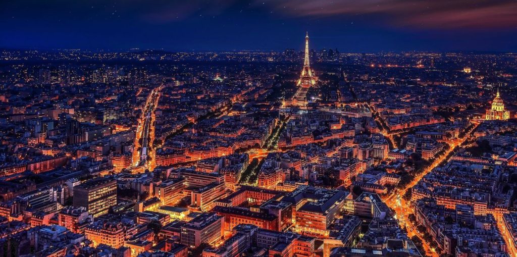 Paris streets lit up at night travel with friends