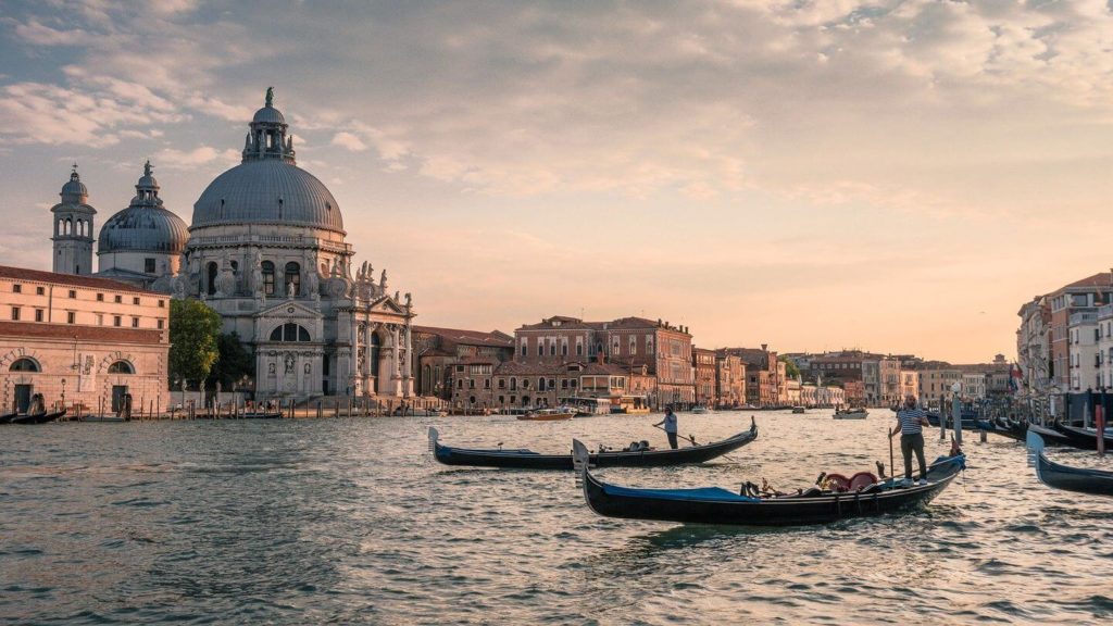 gondolas sailing along canals Venice Italy