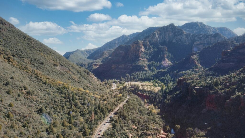 The first fall leaves start to make their appearance on the hillside of Sedona's Oak Creek Canyon.