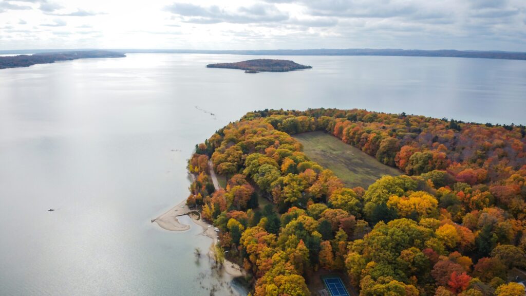 Sparkling Grand Traverse Bay hugging autumn leaves in Michigan.