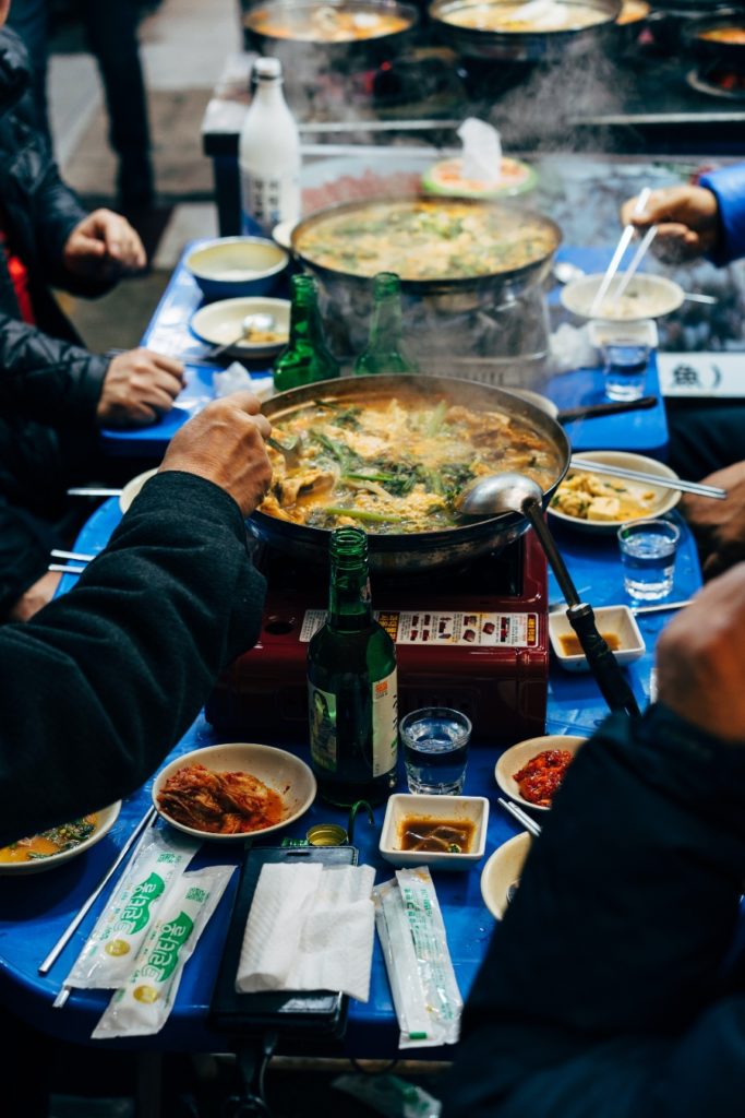 People eating and sharing a meal at a street food stall, enhancing their mental wellbeing.